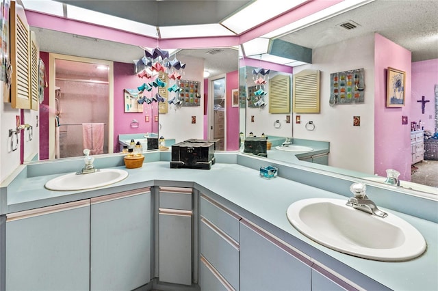 bathroom with vanity and a textured ceiling