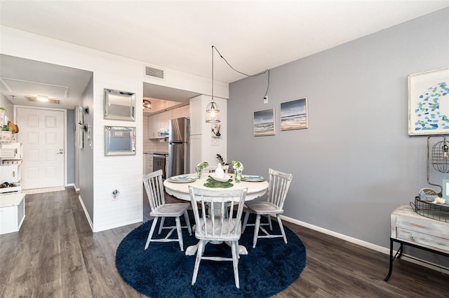 dining space featuring dark wood-type flooring