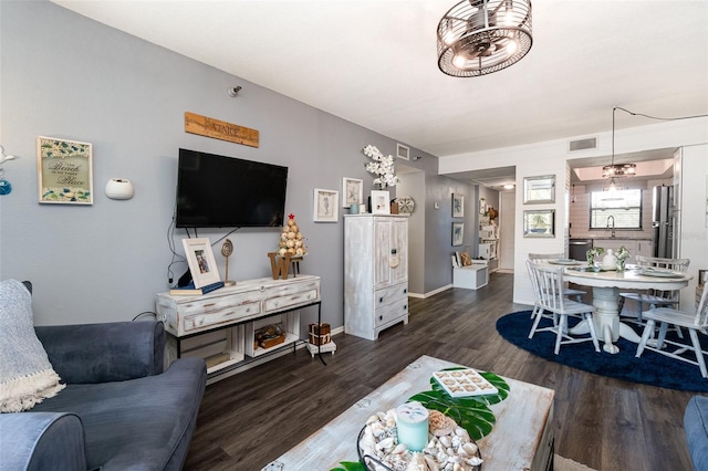 living room with sink and dark hardwood / wood-style floors