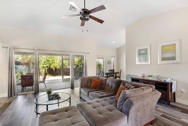 living room with ceiling fan, wood-type flooring, and vaulted ceiling