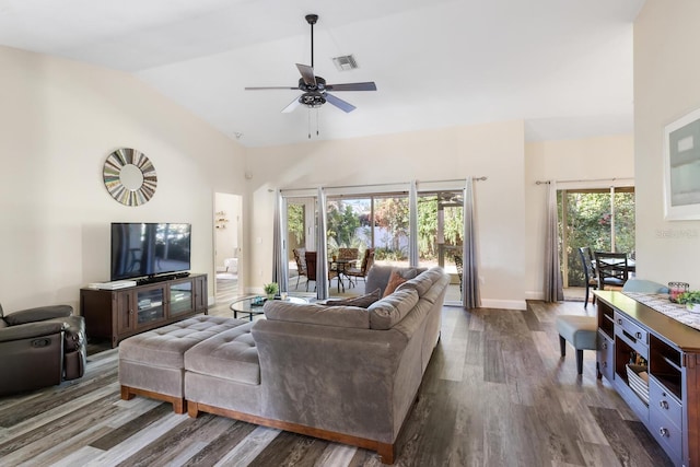 living room with ceiling fan, lofted ceiling, and dark wood-type flooring