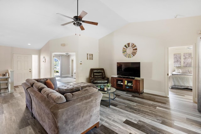 living room featuring hardwood / wood-style floors and vaulted ceiling