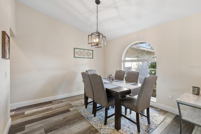 dining space with a notable chandelier and dark wood-type flooring