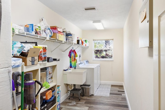 laundry room featuring hardwood / wood-style floors and separate washer and dryer