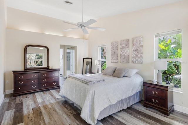 bedroom featuring hardwood / wood-style flooring, ceiling fan, and connected bathroom