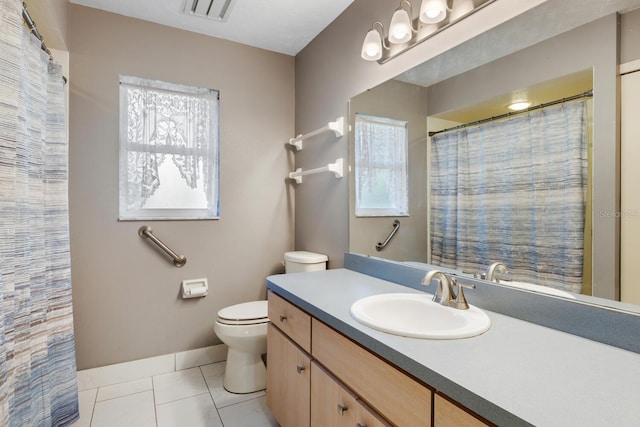 bathroom featuring tile patterned floors, vanity, and toilet