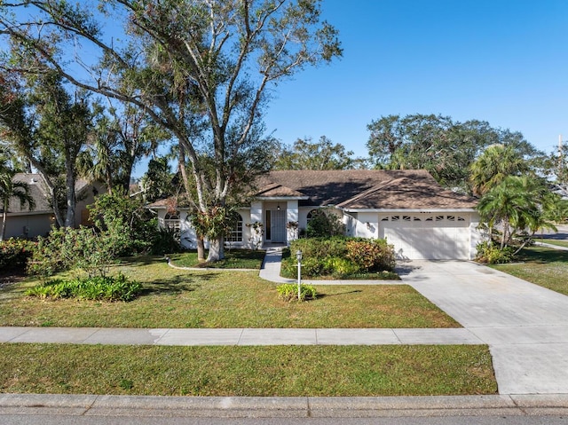 view of front of house with a front yard and a garage