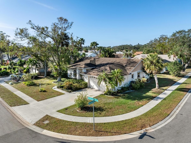 view of front of home featuring a garage and a front yard