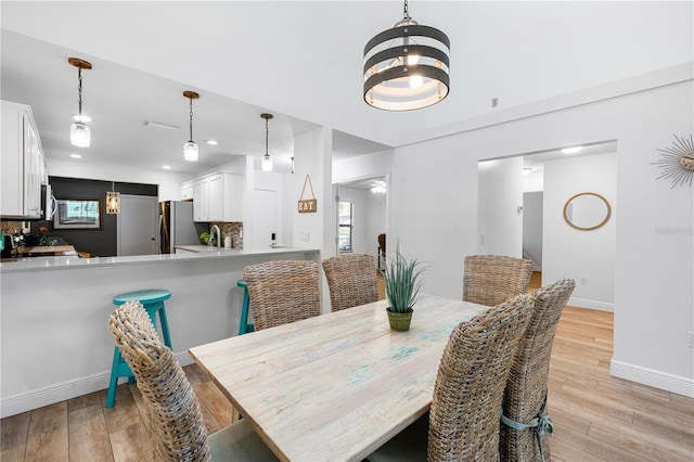 dining room featuring light hardwood / wood-style floors and a chandelier