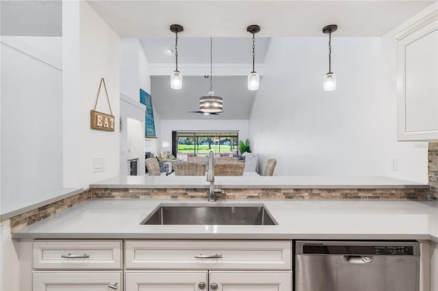 kitchen with sink, white cabinets, stainless steel dishwasher, and decorative light fixtures