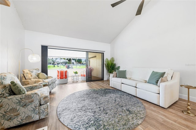 living room featuring light wood-type flooring, ceiling fan, and lofted ceiling