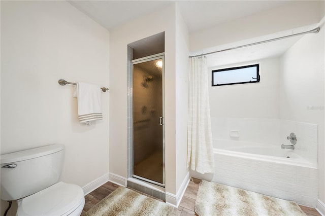 bathroom featuring hardwood / wood-style flooring, shower with separate bathtub, and toilet