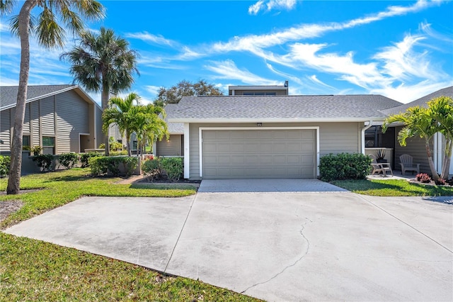 single story home with a front yard and a garage