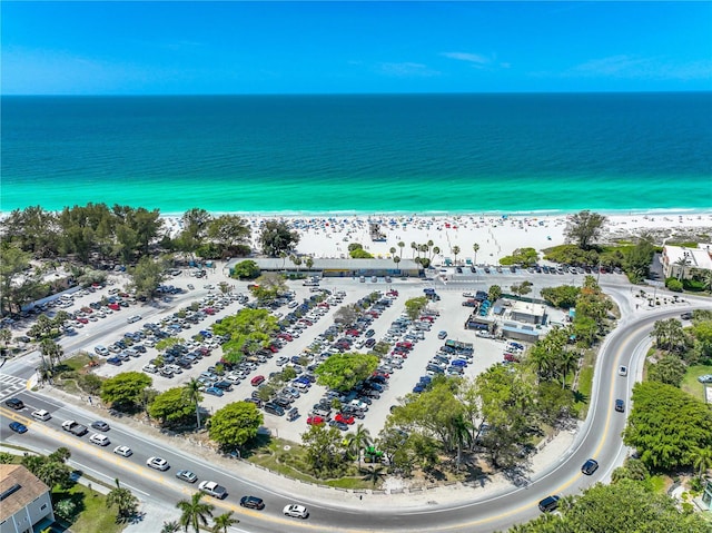 birds eye view of property with a water view and a view of the beach