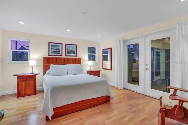 bedroom featuring access to exterior, french doors, and light hardwood / wood-style floors