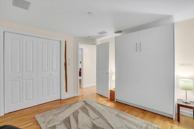 bedroom featuring light wood-type flooring and a closet