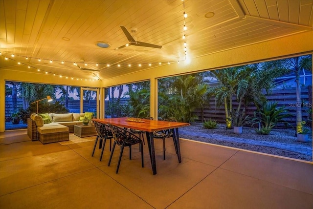 patio terrace at dusk with outdoor lounge area and ceiling fan