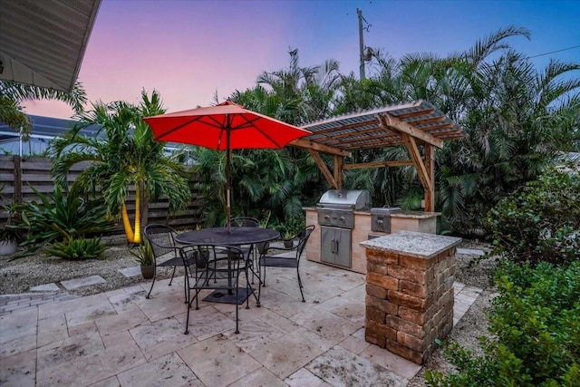 view of patio featuring a grill, area for grilling, and a pergola