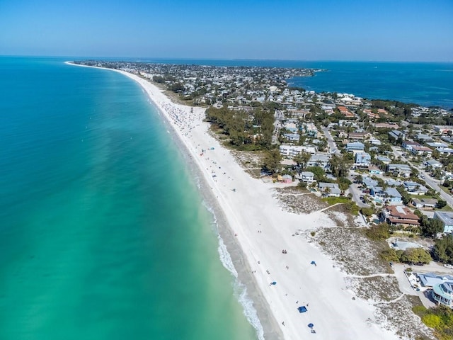 aerial view with a water view and a beach view