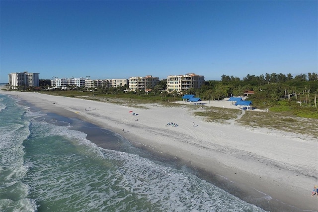 aerial view with a water view and a beach view