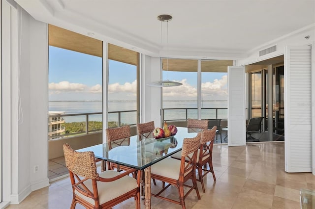 interior space featuring a water view and light tile patterned floors