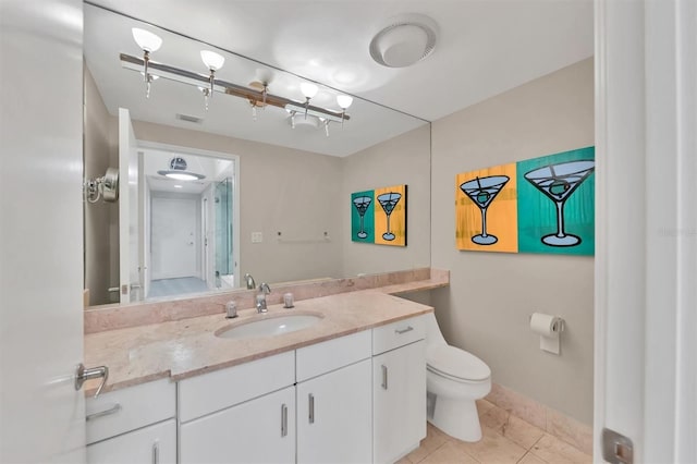 bathroom with tile patterned floors, vanity, and toilet