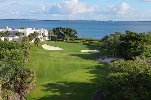 surrounding community with a lawn and a water view