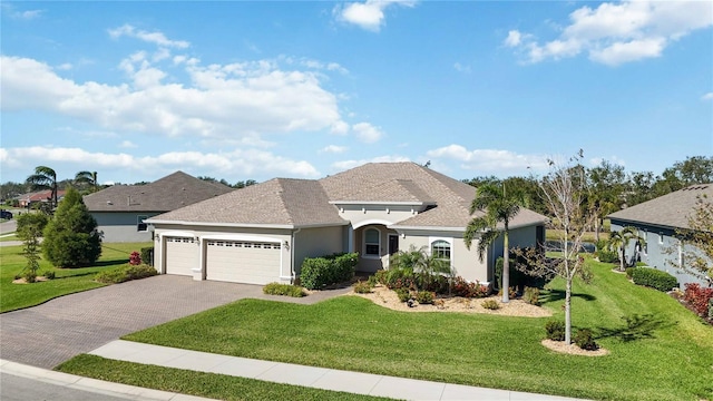 view of front of property with a garage and a front lawn