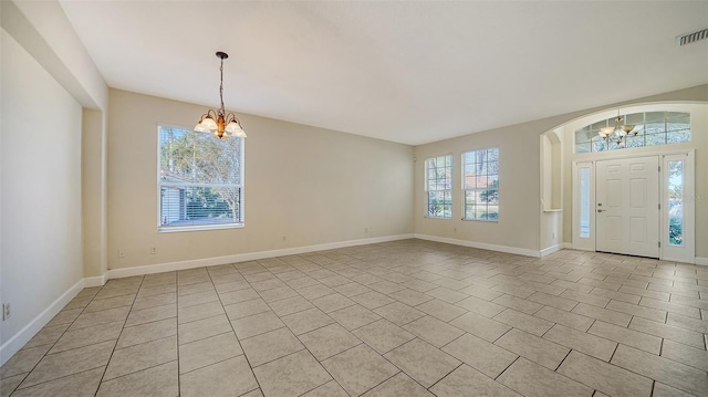 entrance foyer featuring a notable chandelier and light tile patterned flooring