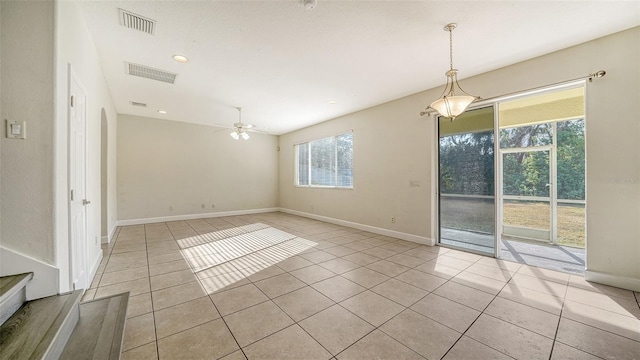 spare room with light tile patterned floors and ceiling fan