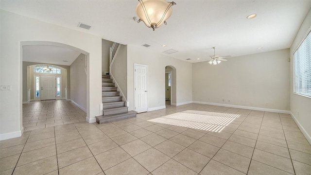 tiled empty room with ceiling fan