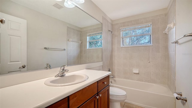 full bathroom featuring tile patterned floors, vanity, toilet, and tiled shower / bath