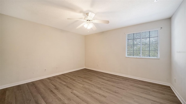 unfurnished room with a textured ceiling, dark hardwood / wood-style floors, and ceiling fan