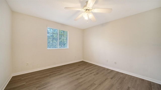 empty room with ceiling fan and dark wood-type flooring