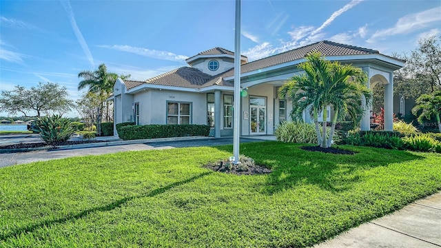 mediterranean / spanish-style house with a front lawn