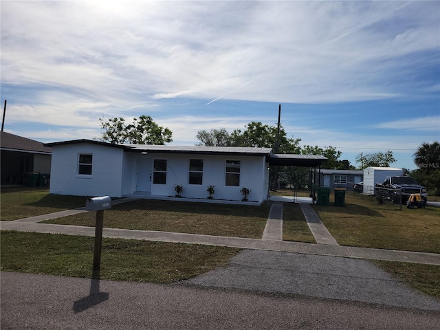 view of front of property with a front lawn and a carport