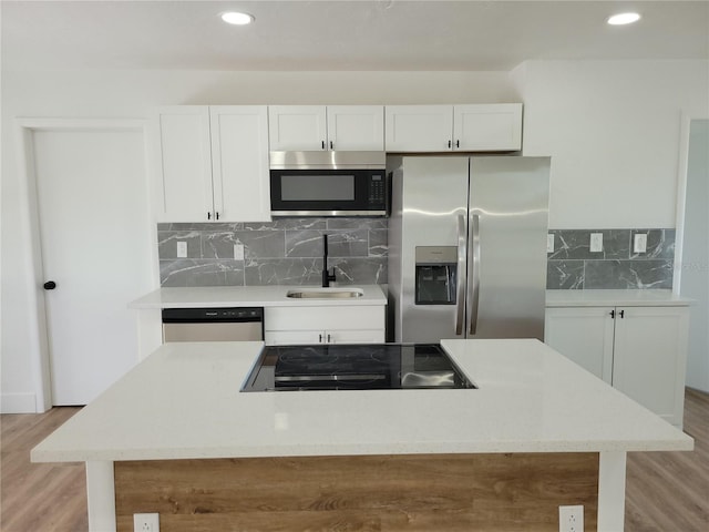 kitchen featuring light hardwood / wood-style floors, sink, white cabinetry, and stainless steel appliances