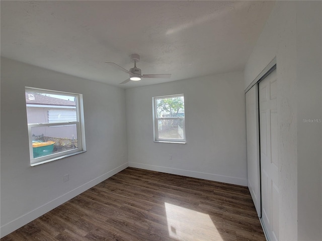 empty room featuring dark hardwood / wood-style floors and ceiling fan