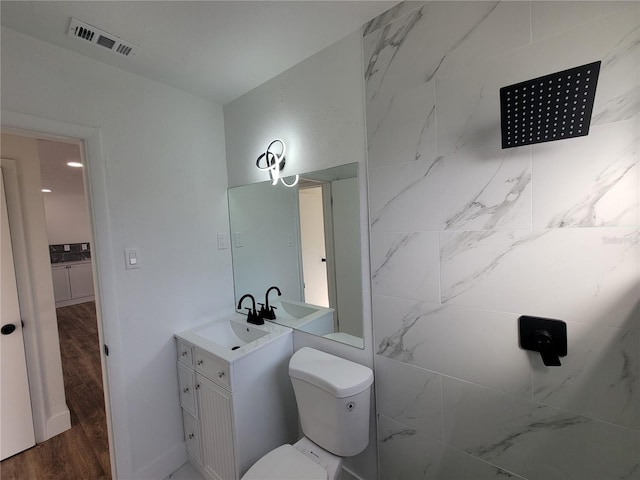 bathroom with hardwood / wood-style floors, vanity, and toilet