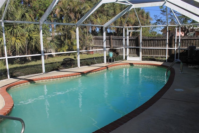 view of swimming pool with glass enclosure