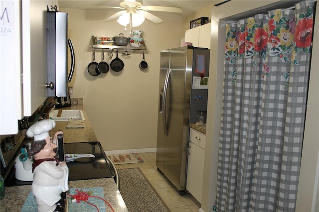 kitchen with ceiling fan, sink, white cabinets, stainless steel fridge with ice dispenser, and light tile patterned flooring