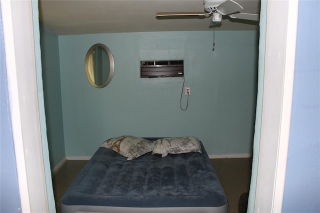 bedroom with a wall unit AC and ceiling fan