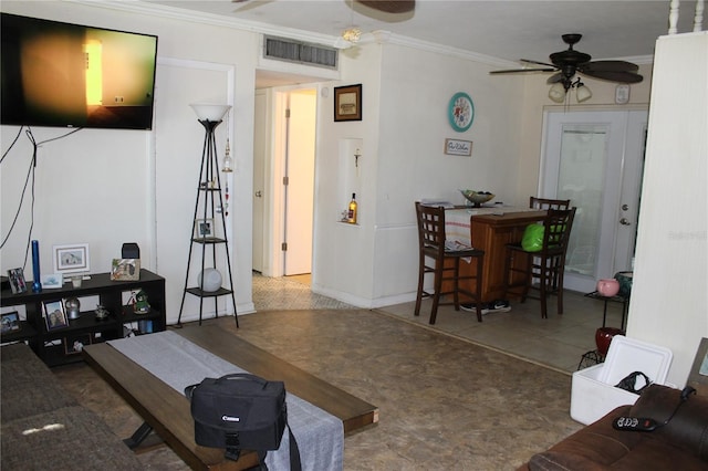 living room with ceiling fan and crown molding