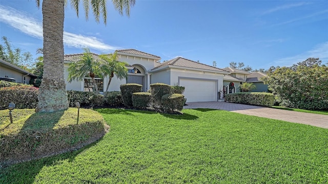 mediterranean / spanish house with a front yard and a garage