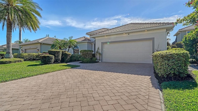 mediterranean / spanish-style home with a front lawn and a garage