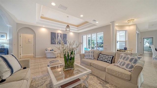 tiled living room with a raised ceiling