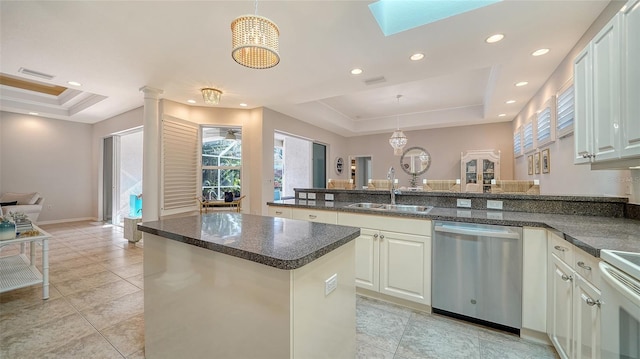 kitchen featuring dishwasher, sink, hanging light fixtures, a tray ceiling, and light tile patterned flooring