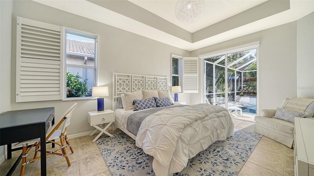 bedroom featuring light tile patterned flooring, a raised ceiling, access to outside, and multiple windows