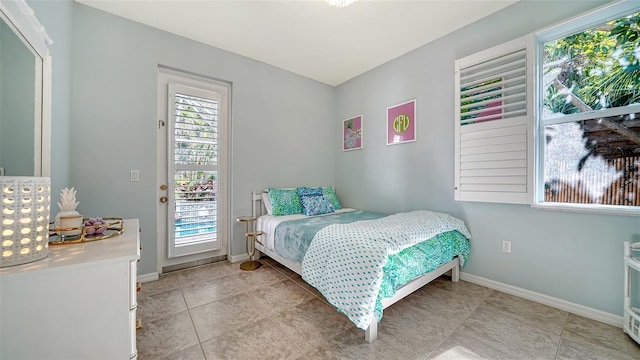 tiled bedroom featuring access to outside