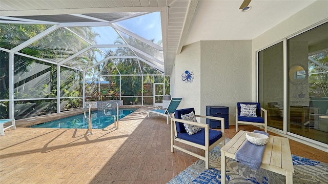 view of pool featuring glass enclosure and a patio area